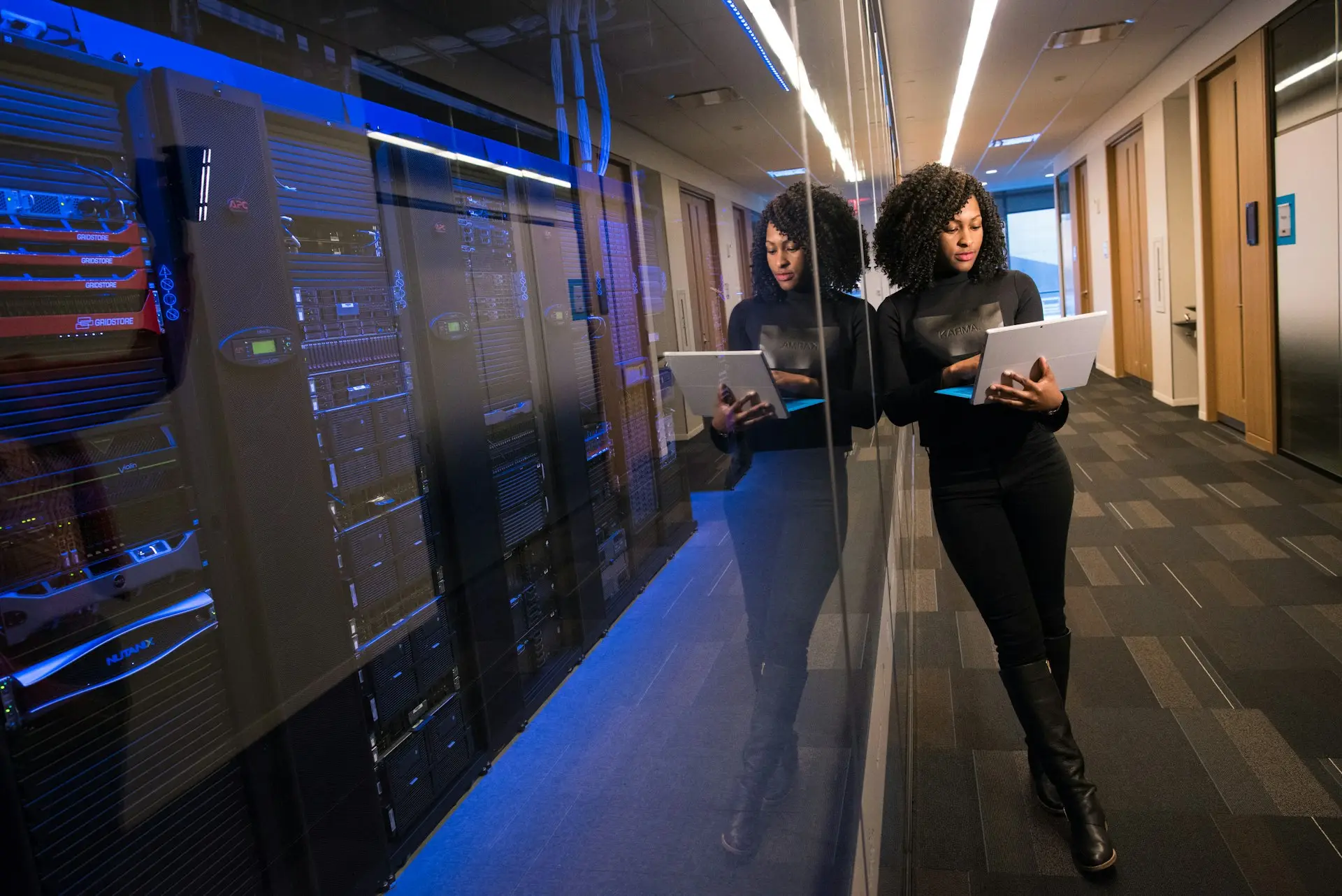 Engineers reviewing equipment in a server room